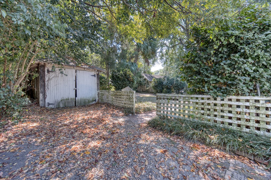2904 Beacon Avenue Columbus, GA 31904 - Photo 7 of 39 a backyard of a house with lots of green space and glass wall