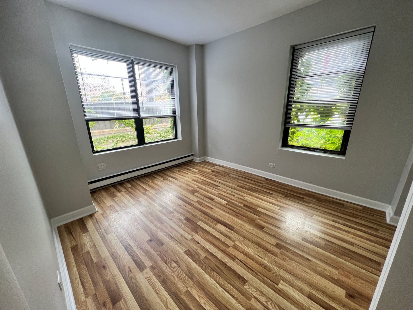 732 West Bittersweet Place, Unit 1208 Chicago, IL 60613 - Photo 12 of 18 a view of an empty room with wooden floor and a window