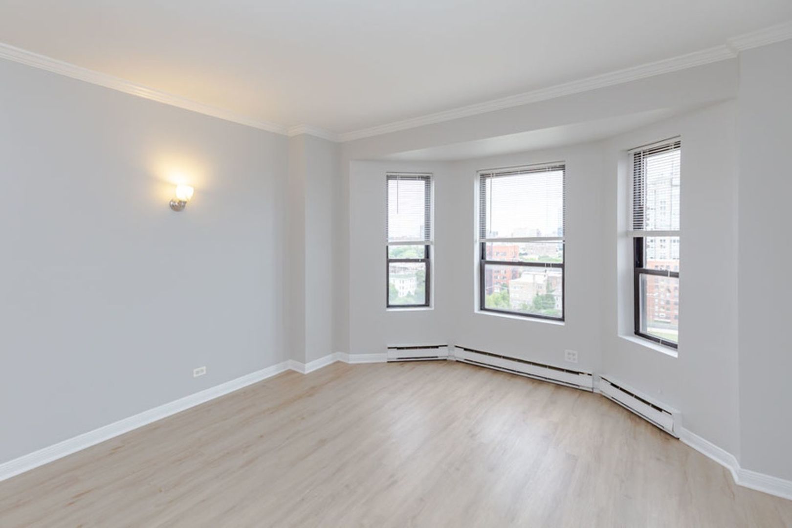 732 West Bittersweet Place, Unit 1208 Chicago, IL 60613 - Photo 8 of 18 an empty room with wooden floor and windows