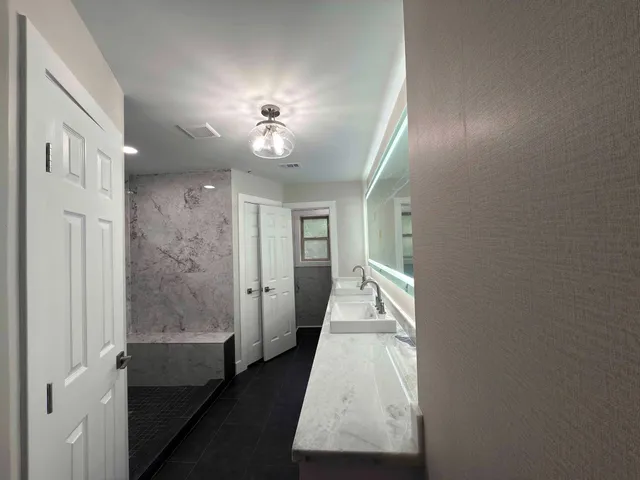 a bathroom with a glass shower door