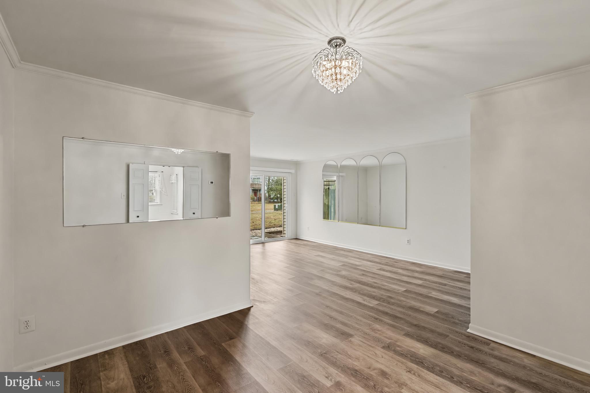 10 Kettle Court, Unit 76F Windsor Mill, MD 21244 - Photo 11 of 29 a view of an empty room with wooden floor and a window