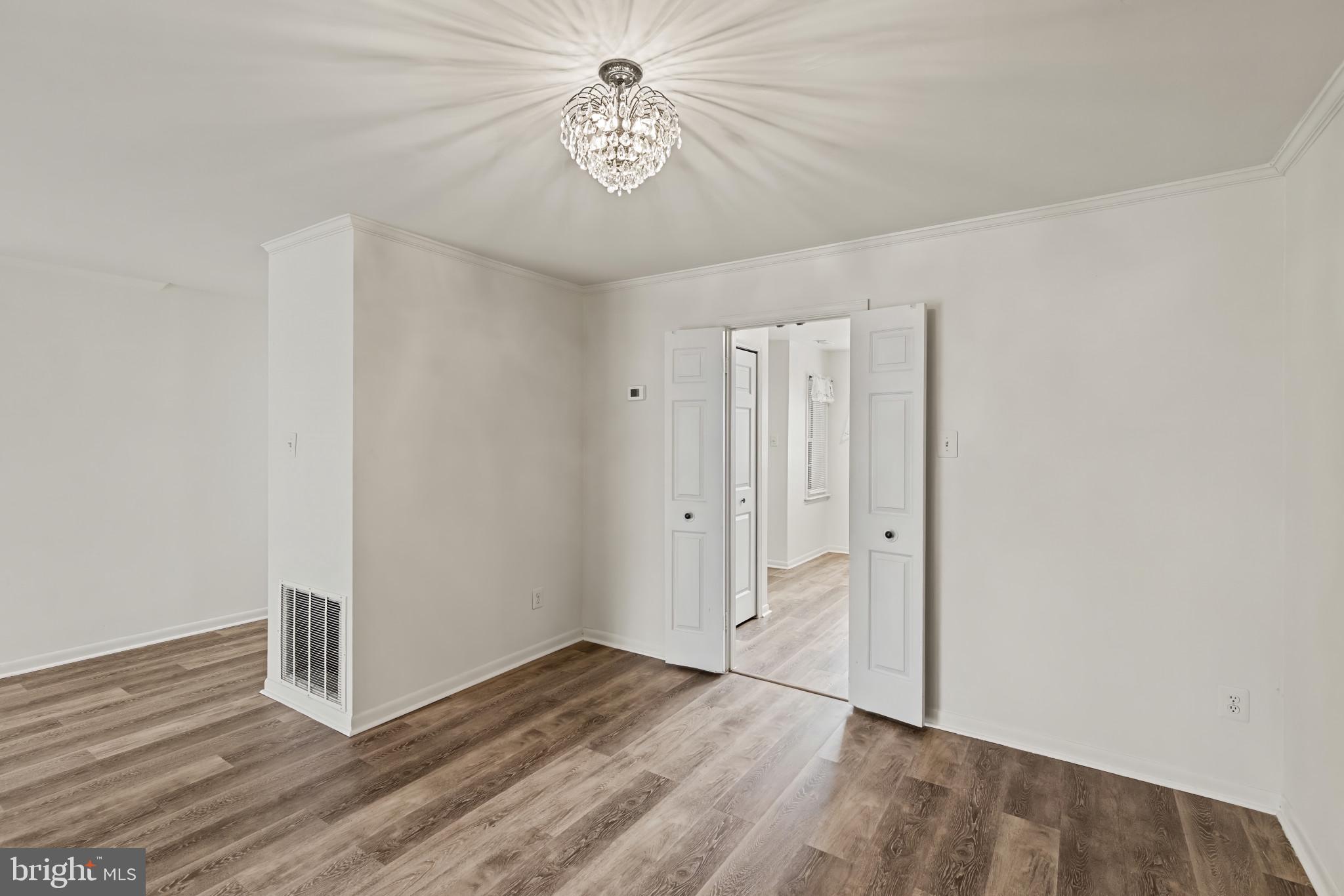 10 Kettle Court, Unit 76F Windsor Mill, MD 21244 - Photo 13 of 29 an empty room with wooden floor and ceiling fan