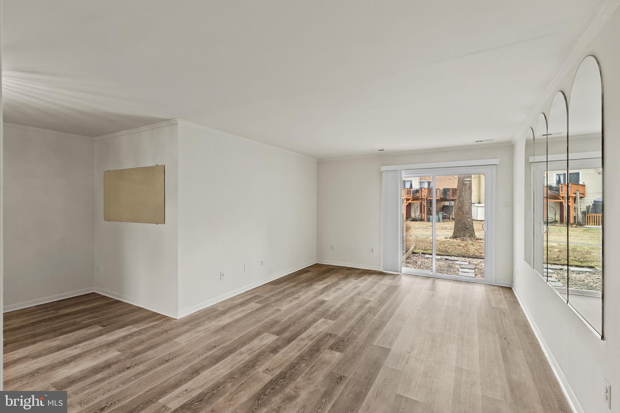 10 Kettle Court, Unit 76F Windsor Mill, MD 21244 - Photo 14 of 29 wooden floor in an empty room with a window