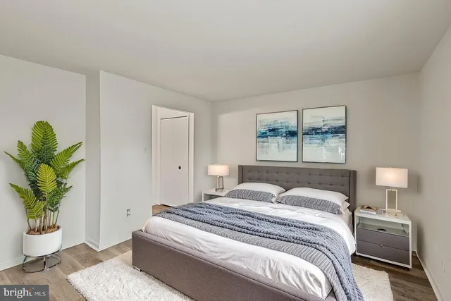 a bedroom with a bed and a painting on the wall