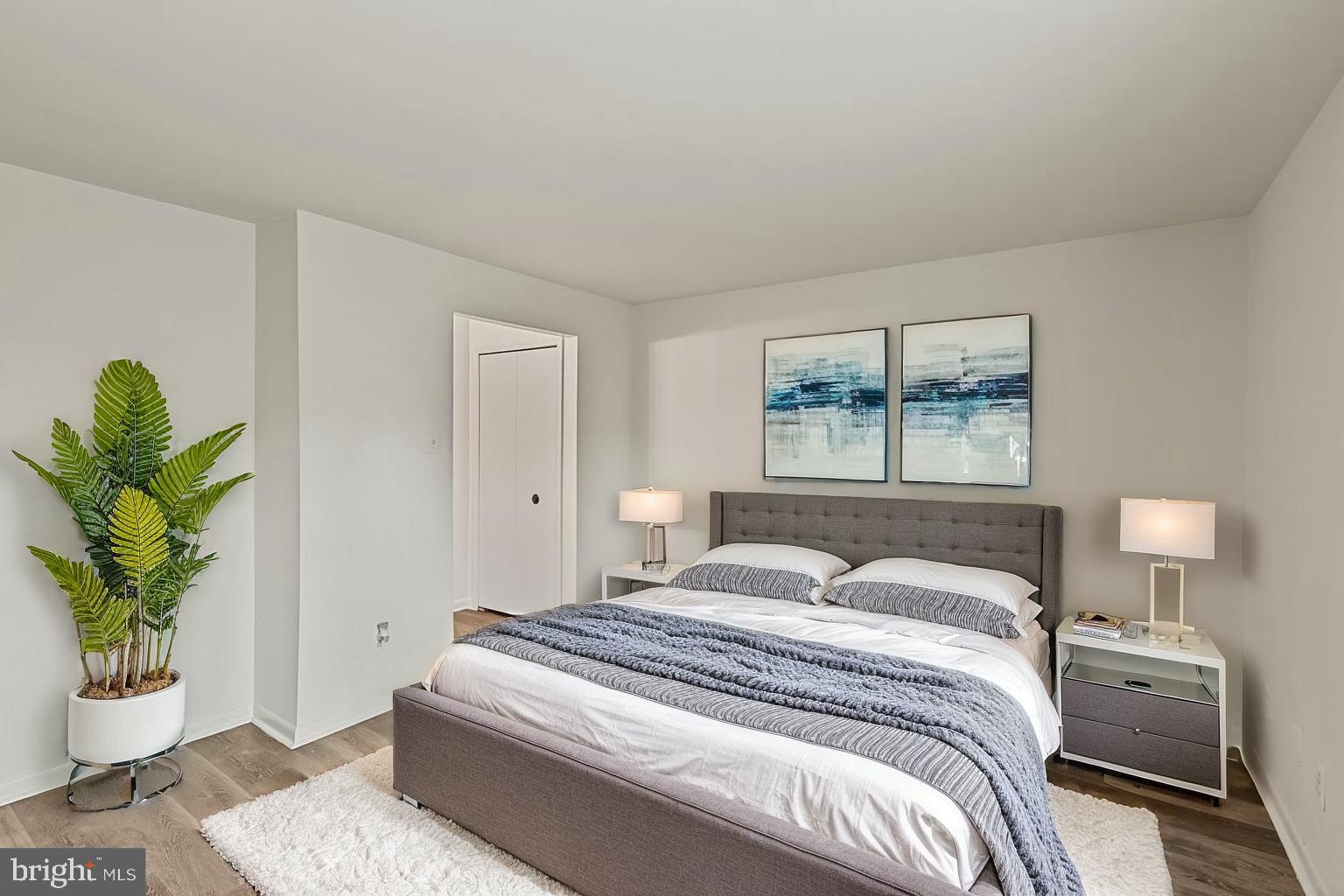 10 Kettle Court, Unit 76F Windsor Mill, MD 21244 - Photo 19 of 29 a bedroom with a bed and a painting on the wall