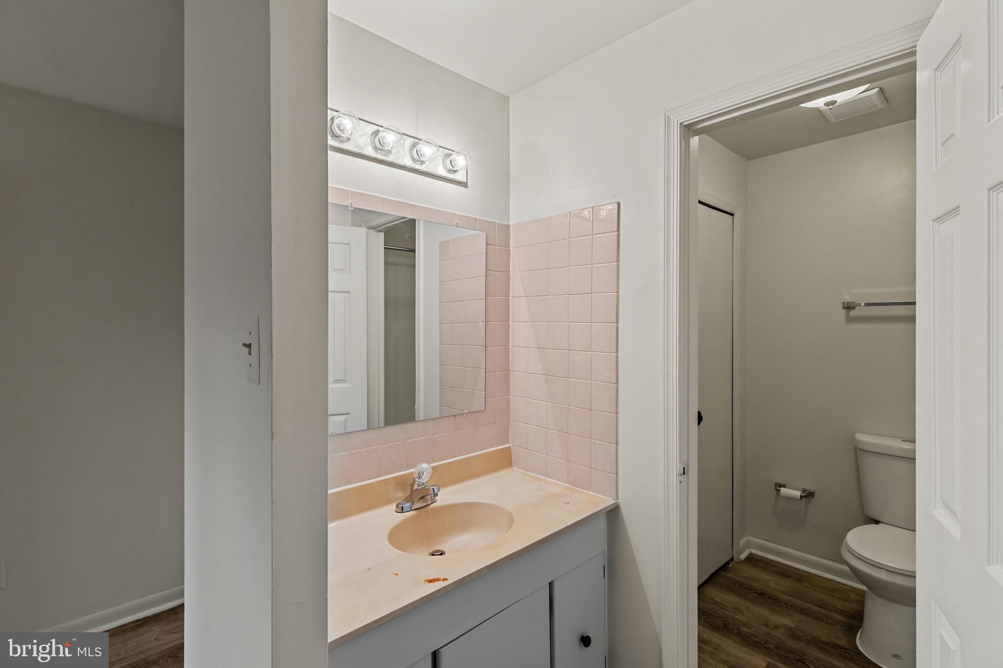 10 Kettle Court, Unit 76F Windsor Mill, MD 21244 - Photo 21 of 29 a bathroom with a sink a toilet and shower