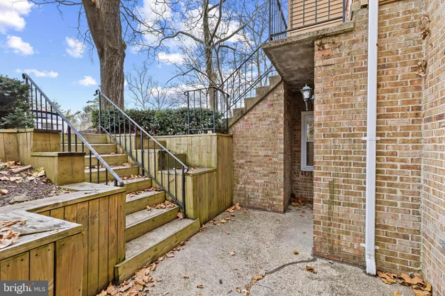 a view of a brick house with a small yard