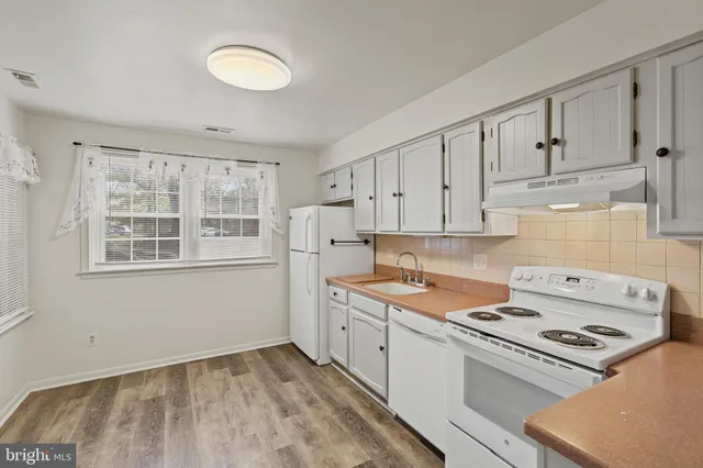 a kitchen with a cabinets and window