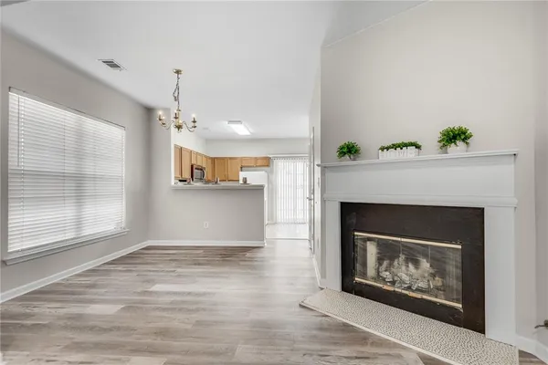 a view of a livingroom with a fireplace and window