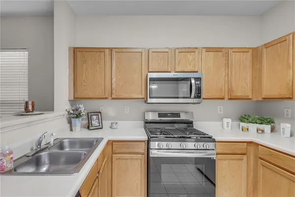 a kitchen with sink a microwave and stove