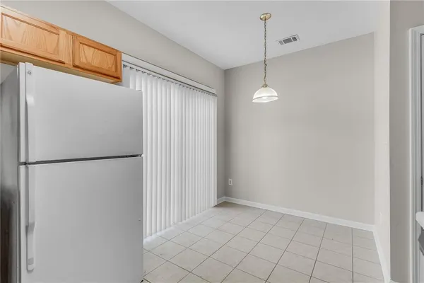 a view of a kitchen with a refrigerator and microwave