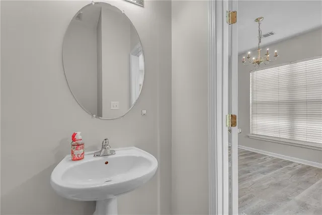 a view of an empty room with wooden floor fireplace and a window