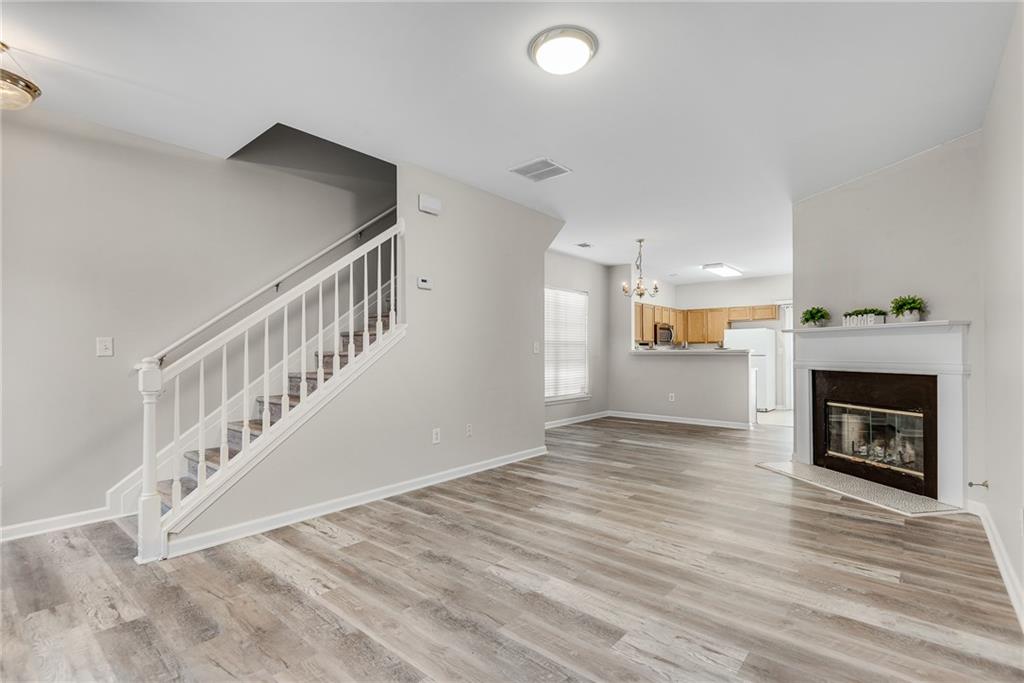 1534 Cove Creek Circle Norcross, GA 30093 - Photo 19 of 33 a view of an empty room with wooden floor fireplace and a window