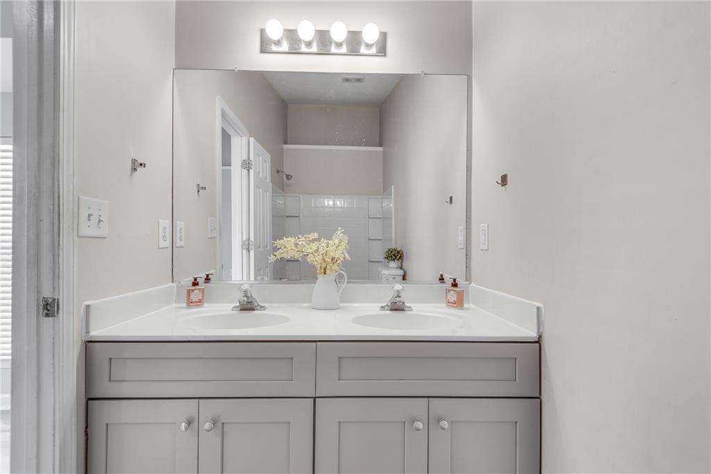 1534 Cove Creek Circle Norcross, GA 30093 - Photo 22 of 33 a bathroom with a sink vanity and a mirror