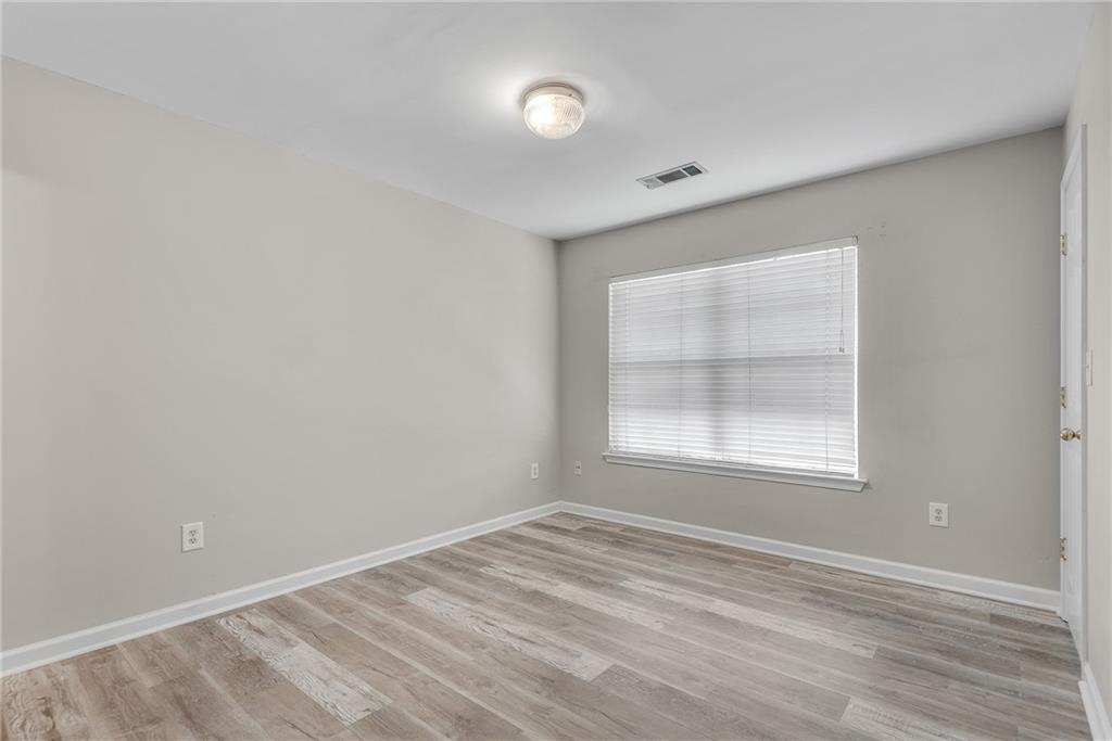 1534 Cove Creek Circle Norcross, GA 30093 - Photo 24 of 33 an empty room with wooden floor and windows