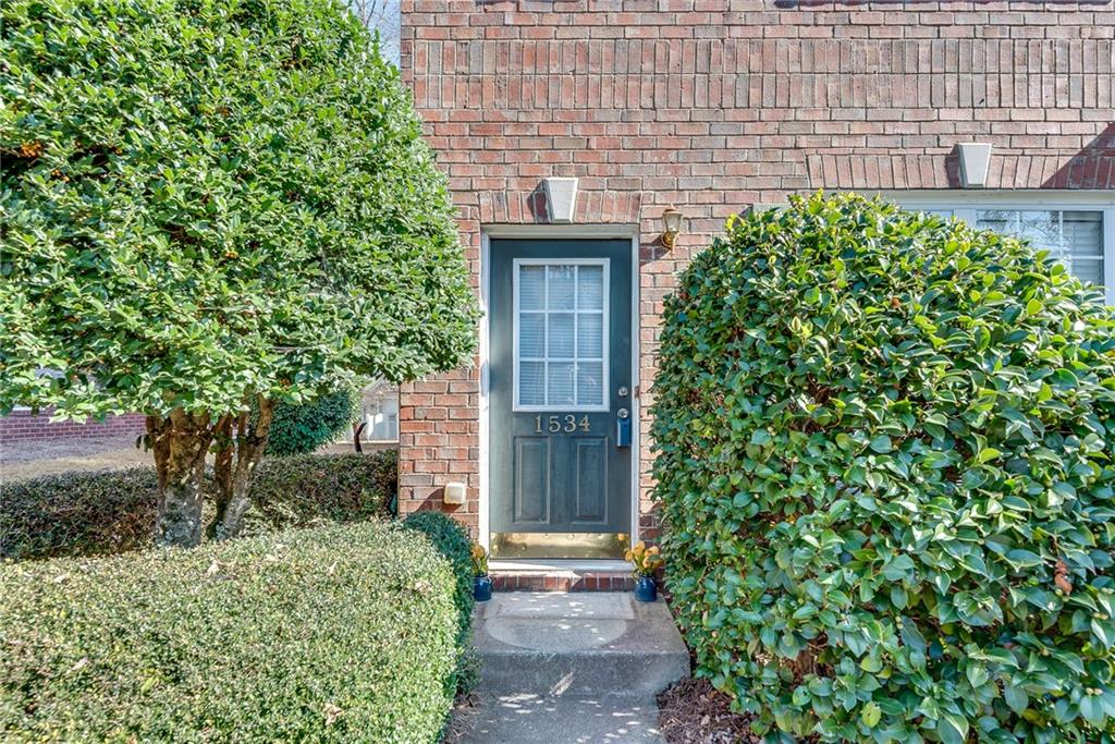 1534 Cove Creek Circle Norcross, GA 30093 - Photo 6 of 33 a front view of a house with a garden