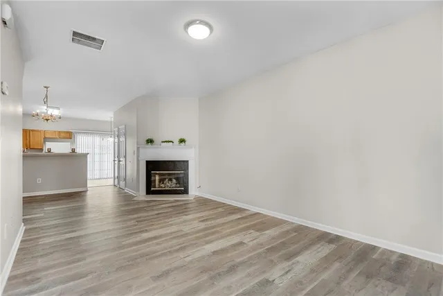 a view of livingroom with a fireplace wooden floor and window