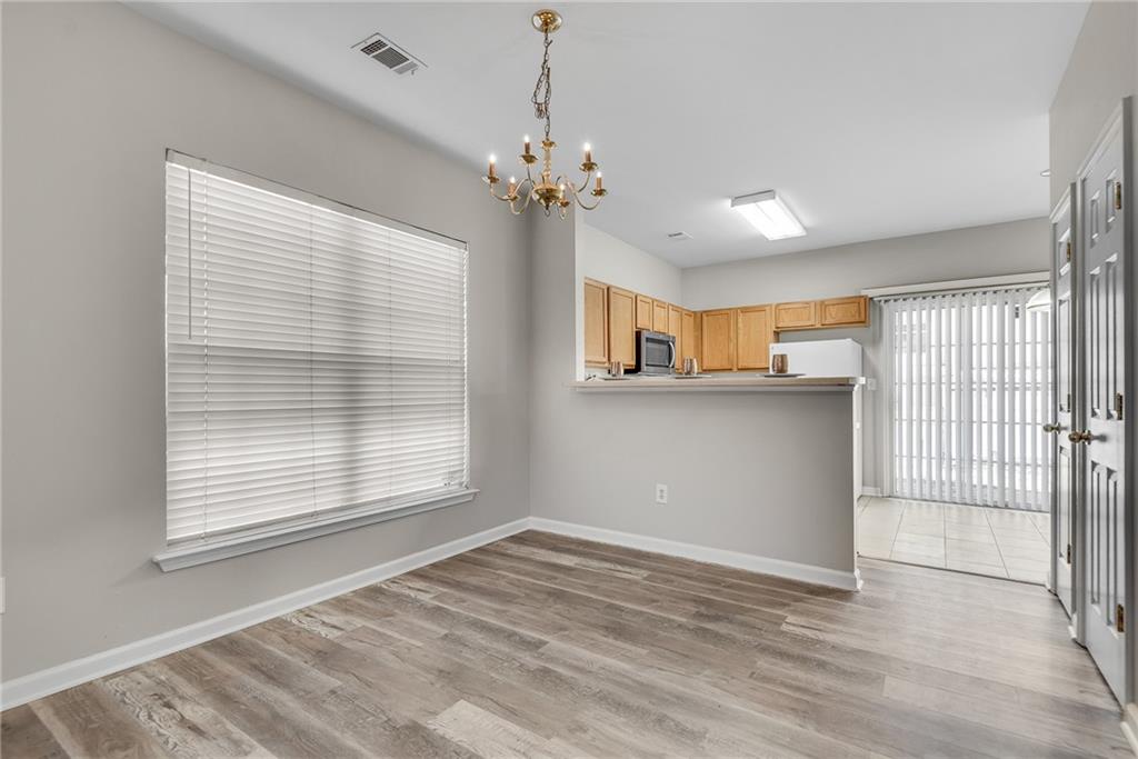 1534 Cove Creek Circle Norcross, GA 30093 - Photo 10 of 33 a view of a livingroom with a chandelier fan and windows