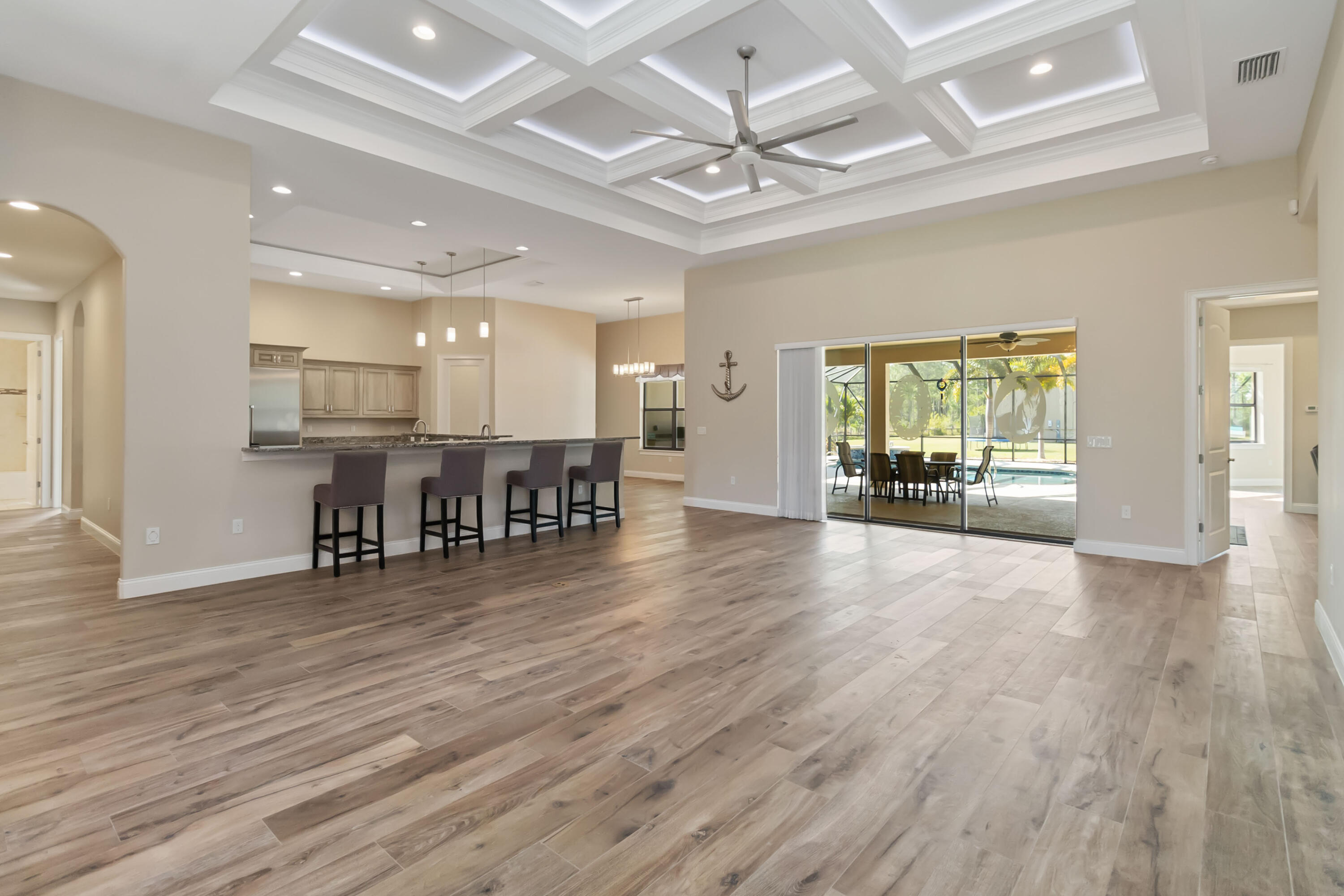 3640 Corey Road Grant Valkaria, FL 32950 - Photo 13 of 77 a view of an empty room with wooden floor and windows