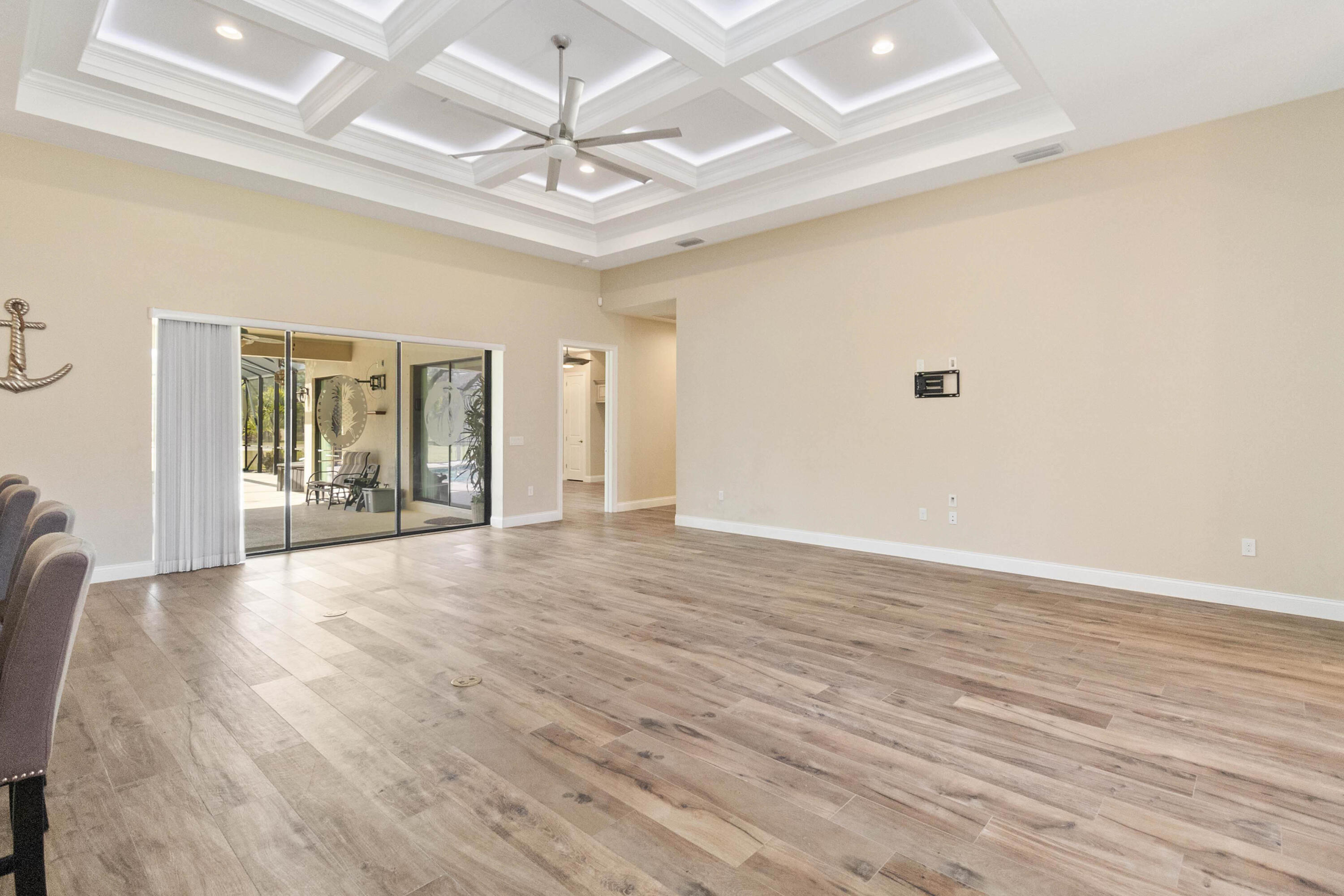 3640 Corey Road Grant Valkaria, FL 32950 - Photo 15 of 77 wooden floor in an empty room with a chandelier