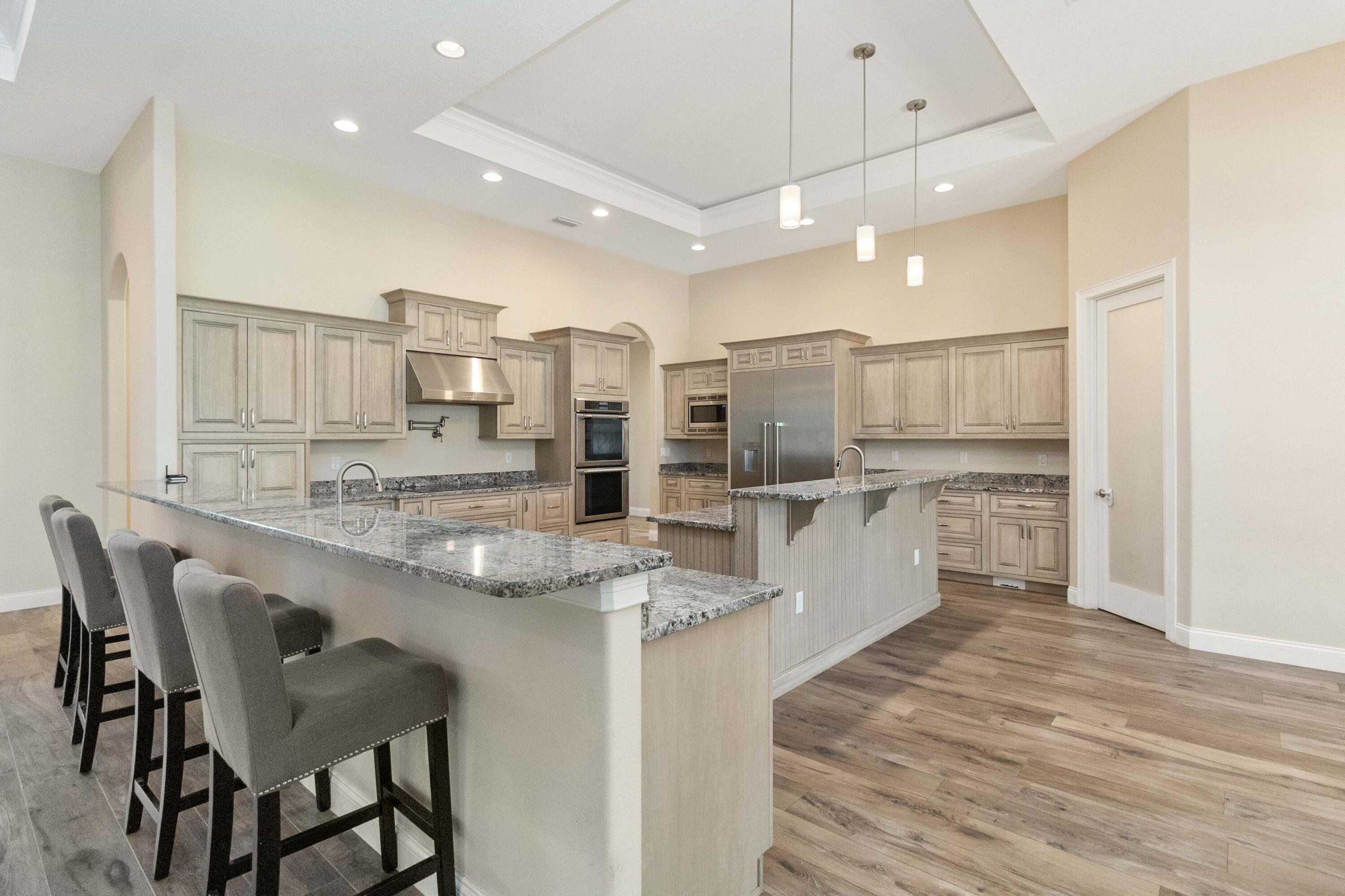 3640 Corey Road Grant Valkaria, FL 32950 - Photo 16 of 77 a large kitchen with kitchen island a sink table and chairs