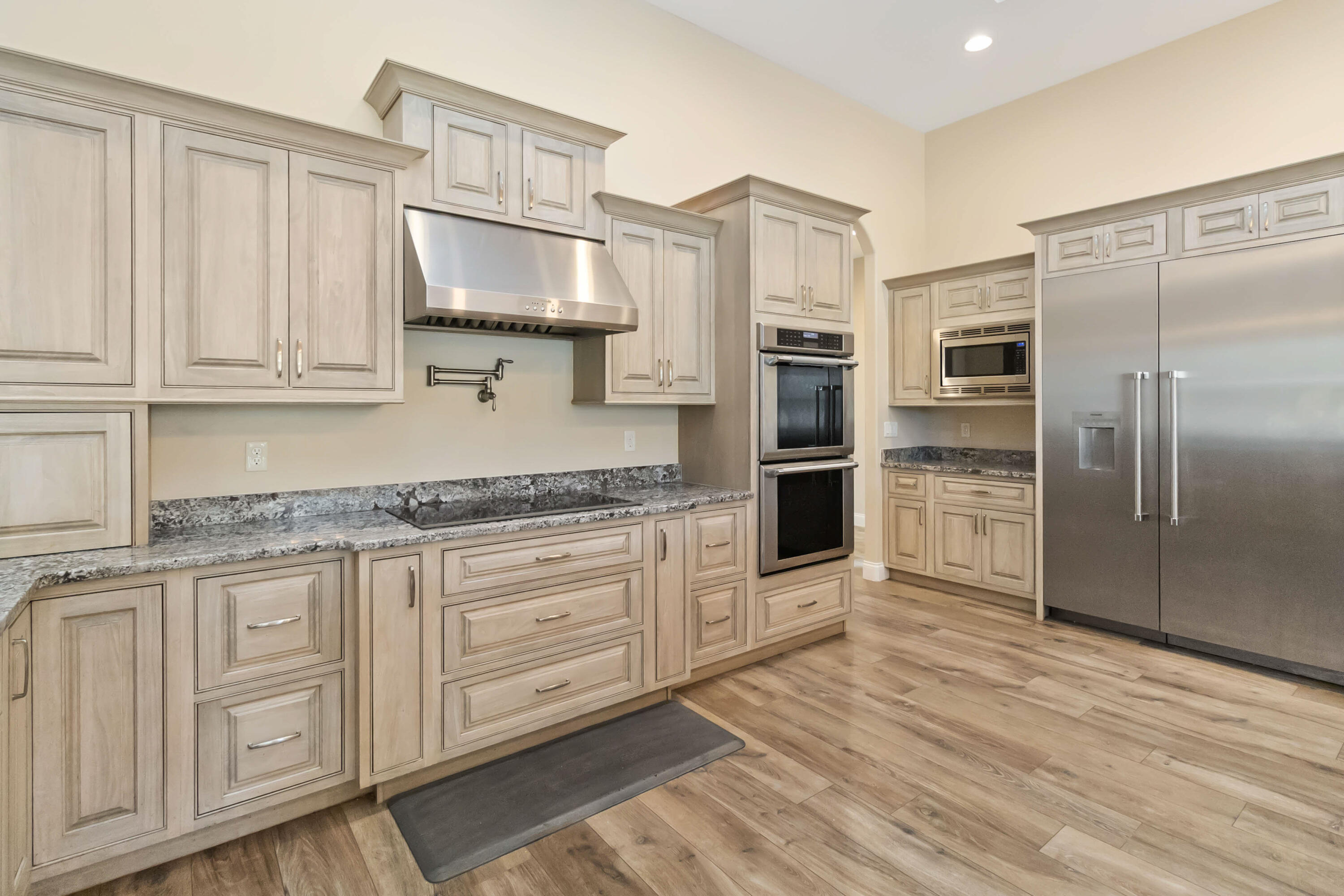 3640 Corey Road Grant Valkaria, FL 32950 - Photo 21 of 77 a kitchen with stainless steel appliances granite countertop a refrigerator and a sink