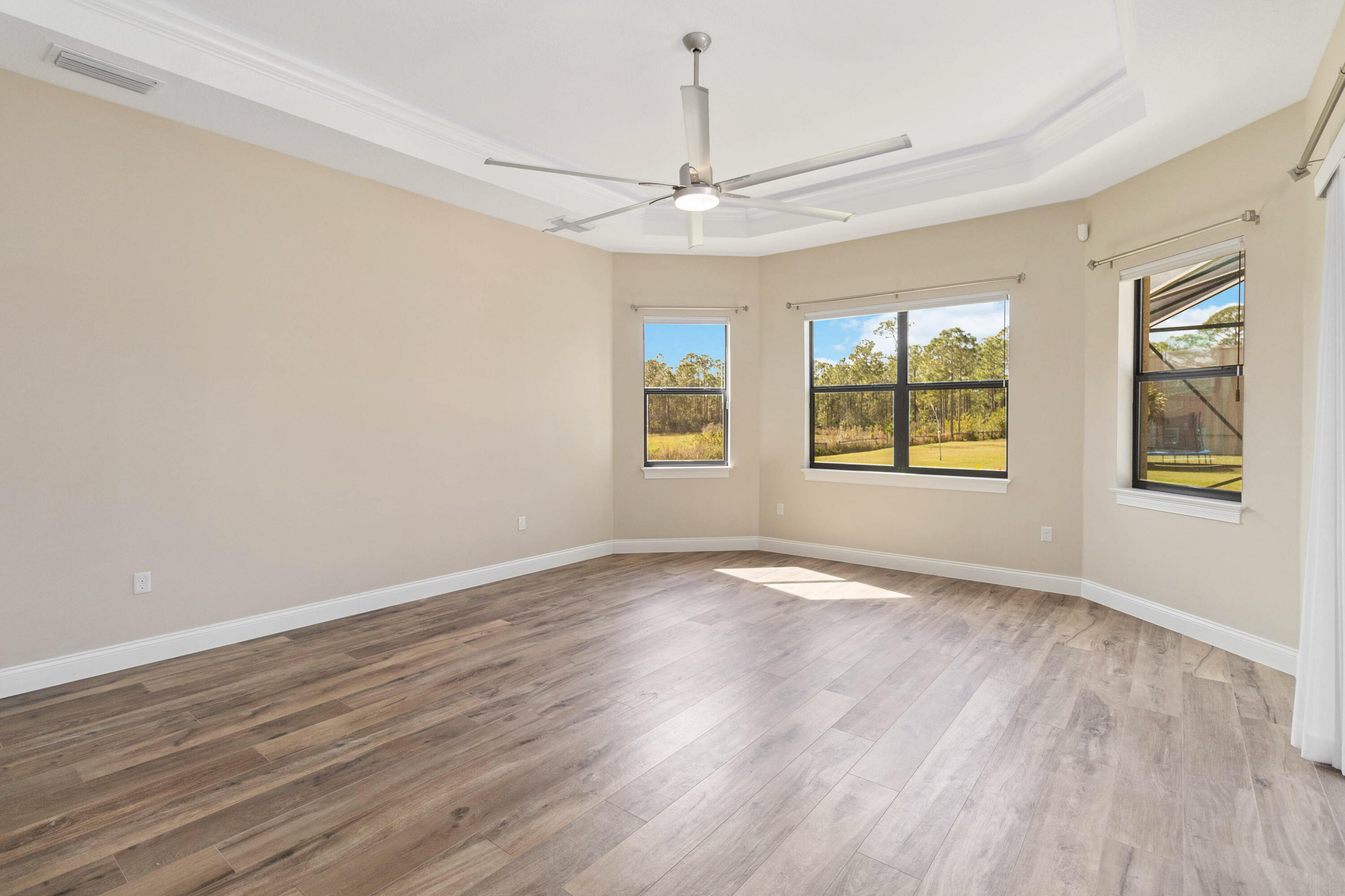 3640 Corey Road Grant Valkaria, FL 32950 - Photo 25 of 77 a view of an empty room with a window and wooden floor