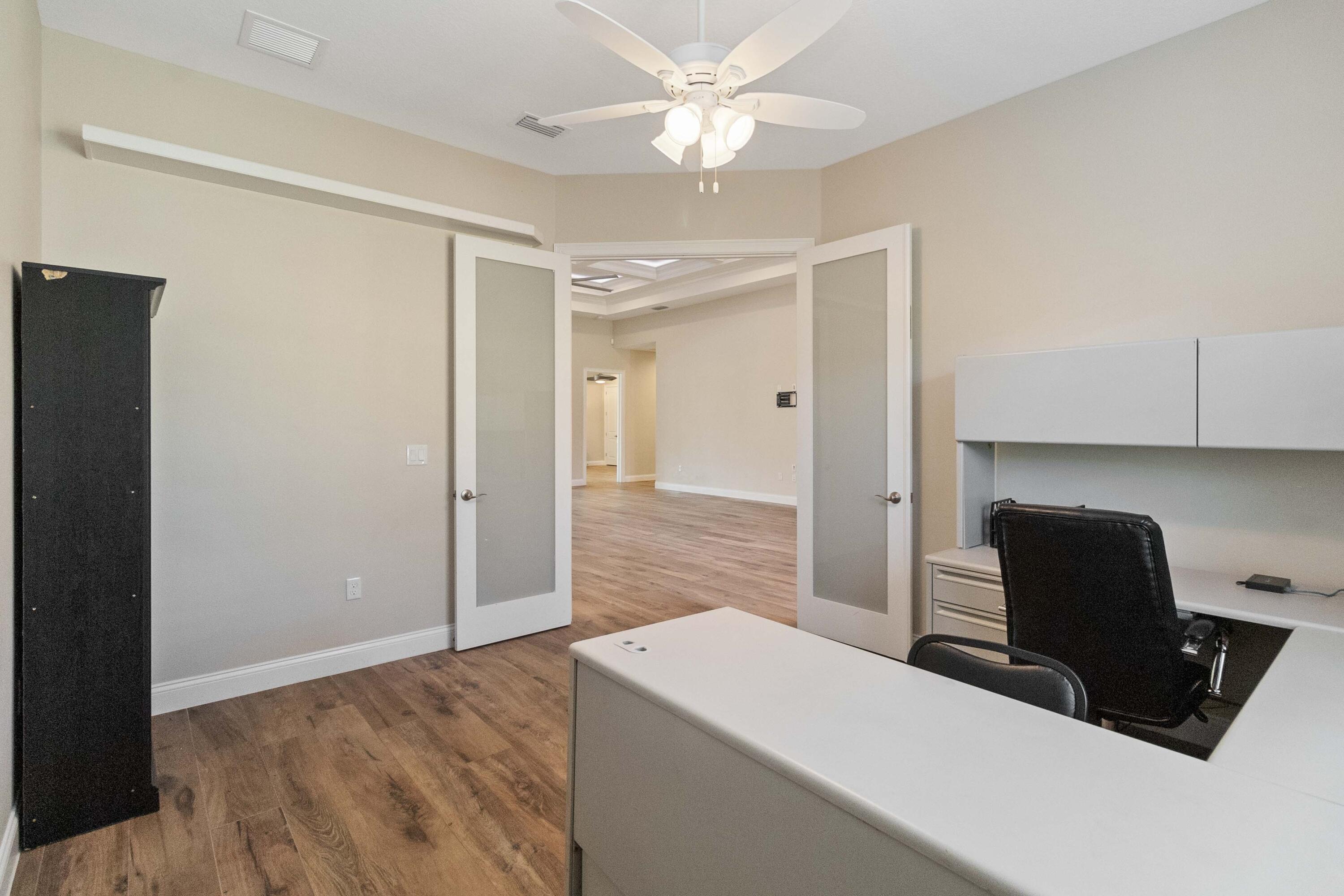 3640 Corey Road Grant Valkaria, FL 32950 - Photo 35 of 77 a living room with furniture and a chandelier fan