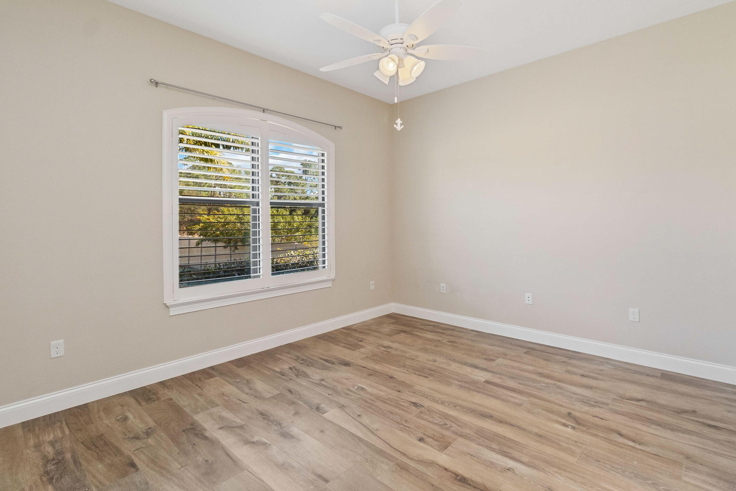 3640 Corey Road Grant Valkaria, FL 32950 - Photo 40 of 77 a view of an empty room with wooden floor and a window
