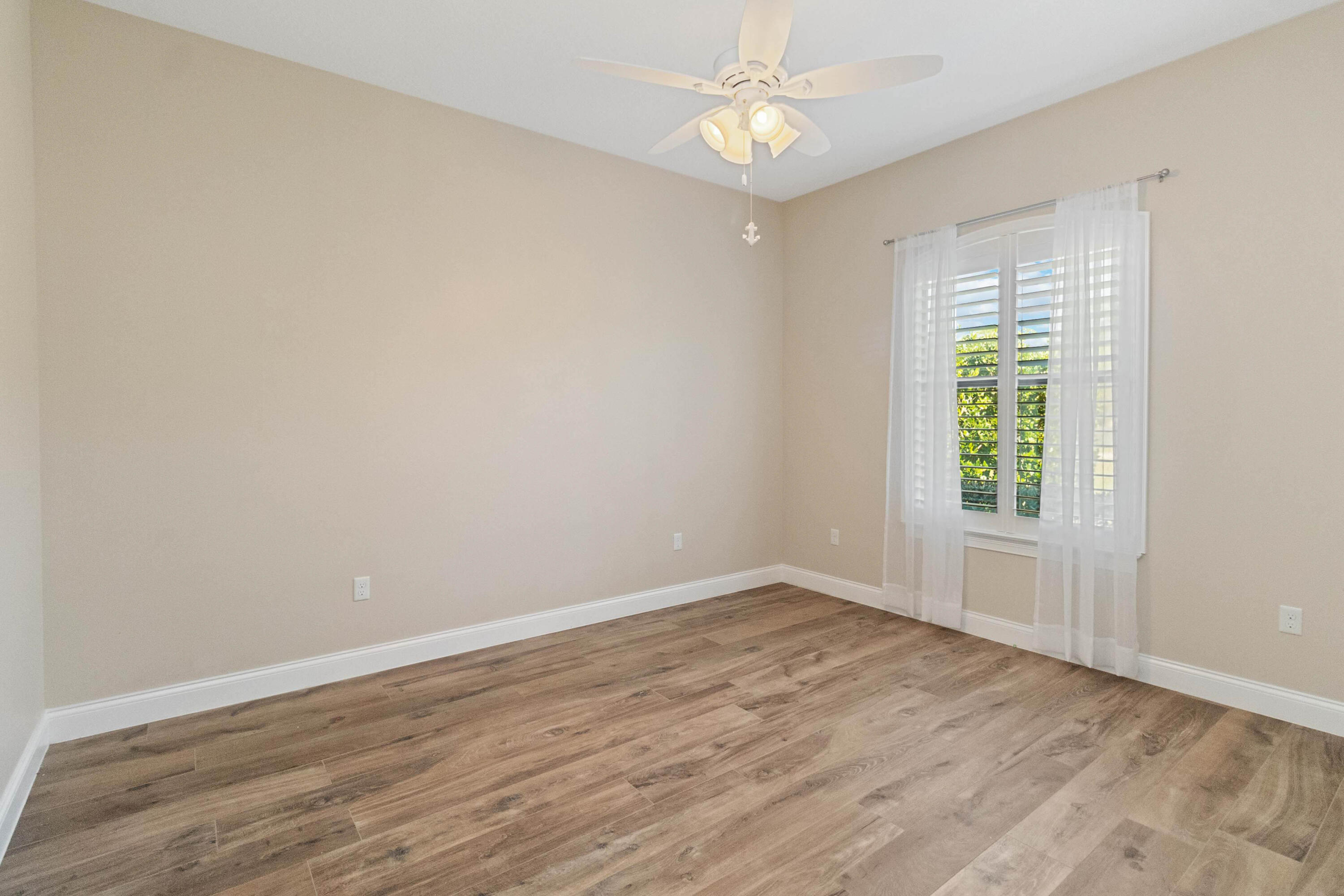 3640 Corey Road Grant Valkaria, FL 32950 - Photo 42 of 77 a view of an empty room with wooden floor and a window