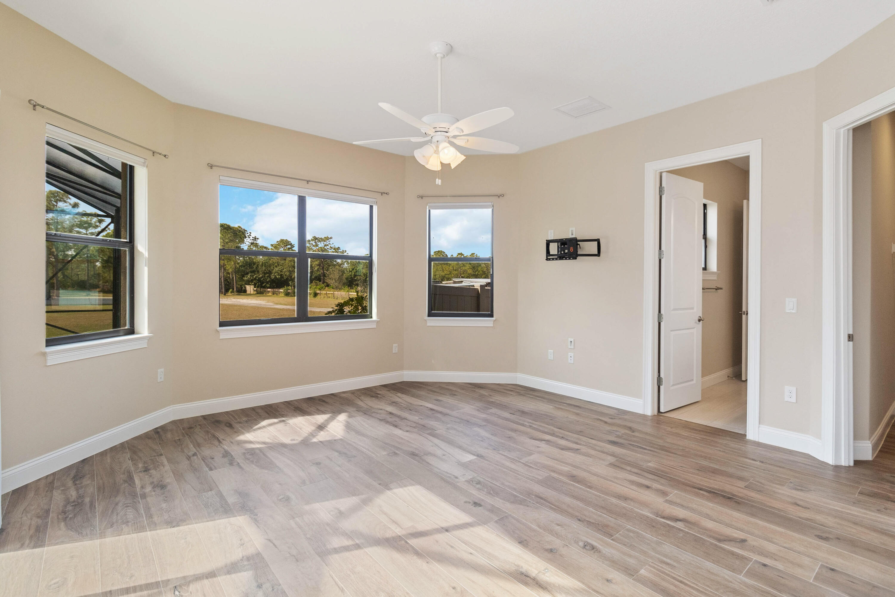 3640 Corey Road Grant Valkaria, FL 32950 - Photo 49 of 77 a view of an empty room with window and chandelier fan