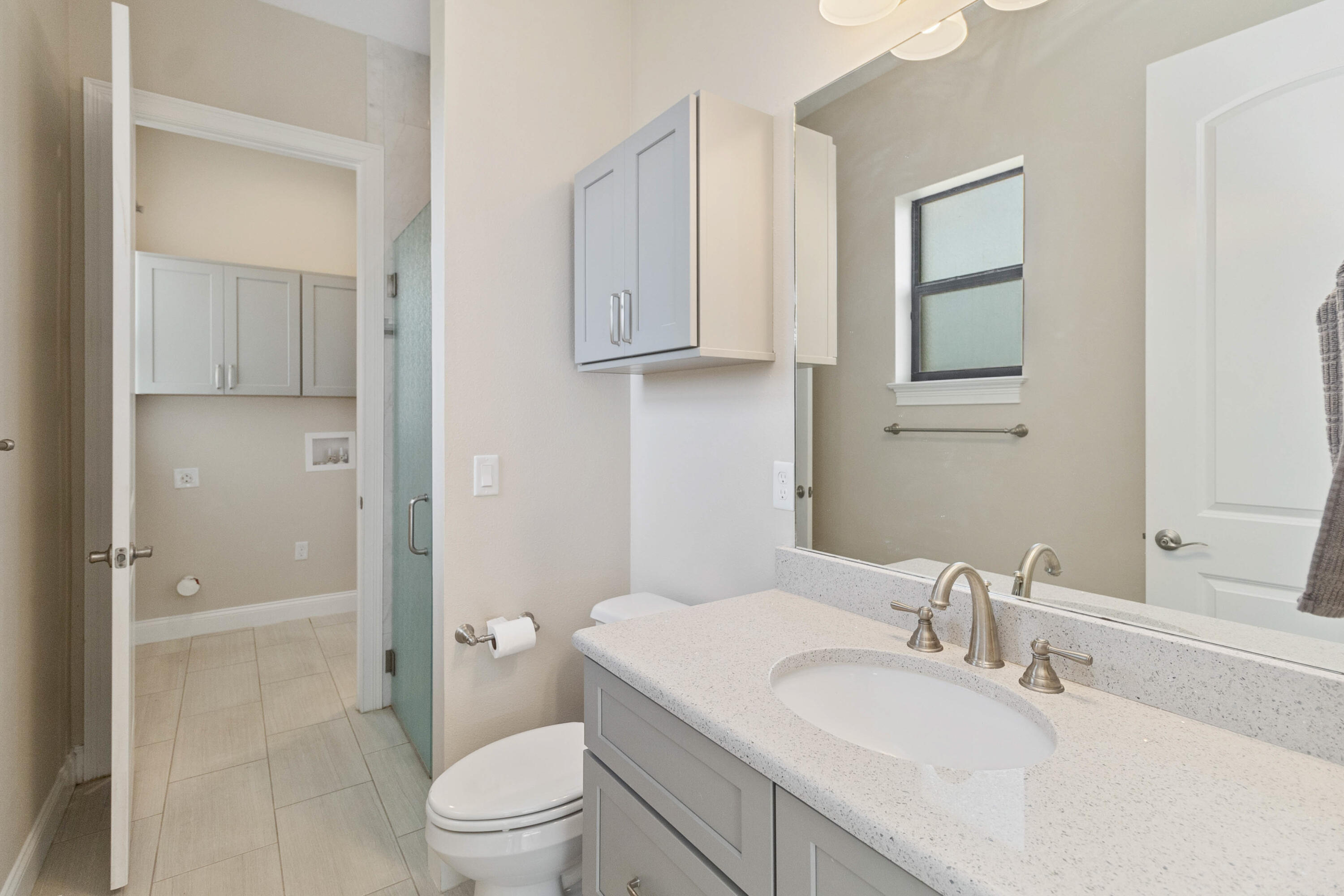 3640 Corey Road Grant Valkaria, FL 32950 - Photo 51 of 77 a bathroom with a granite countertop sink toilet a mirror and shower