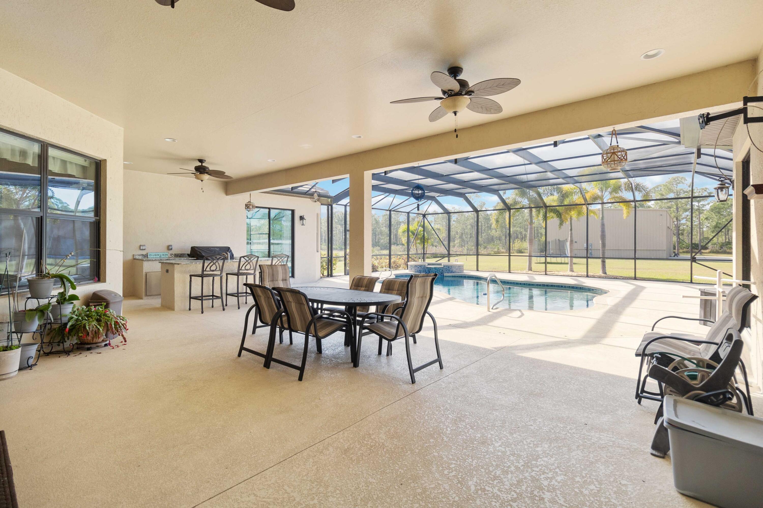 3640 Corey Road Grant Valkaria, FL 32950 - Photo 57 of 77 a dining room with furniture and a floor to ceiling window