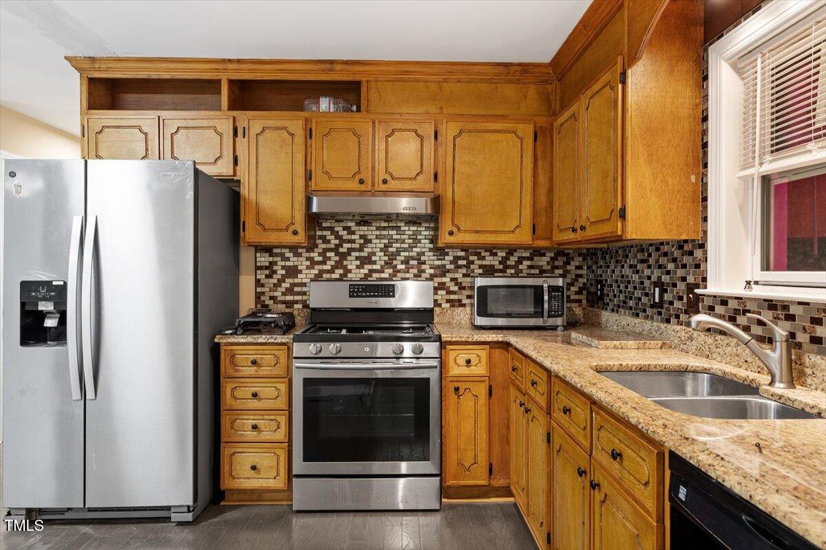 3605 Satellite Court Raleigh, NC 27604 - Photo 10 of 37 a kitchen with stainless steel appliances granite countertop a sink stove and refrigerator