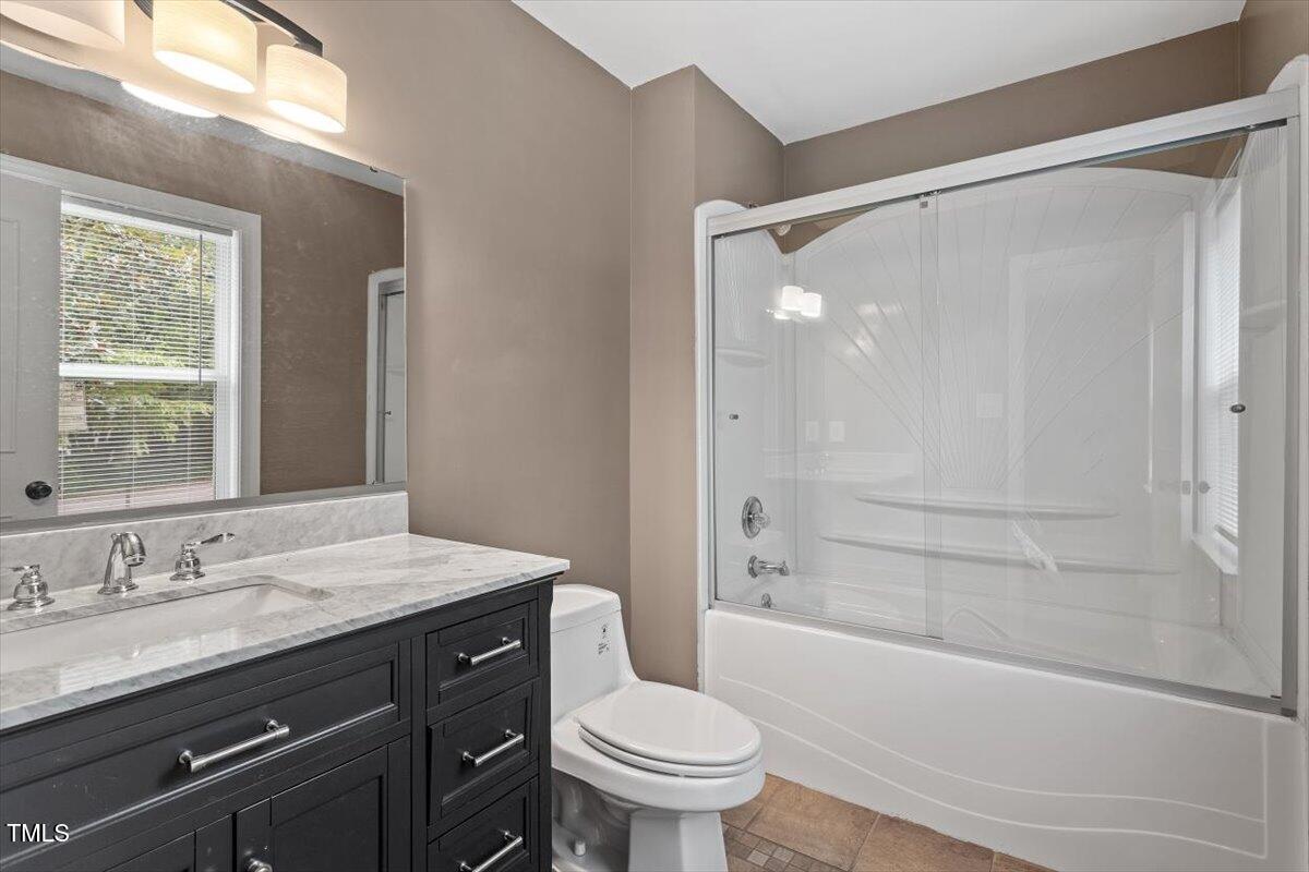 3605 Satellite Court Raleigh, NC 27604 - Photo 25 of 37 a bathroom with a granite countertop sink toilet and shower