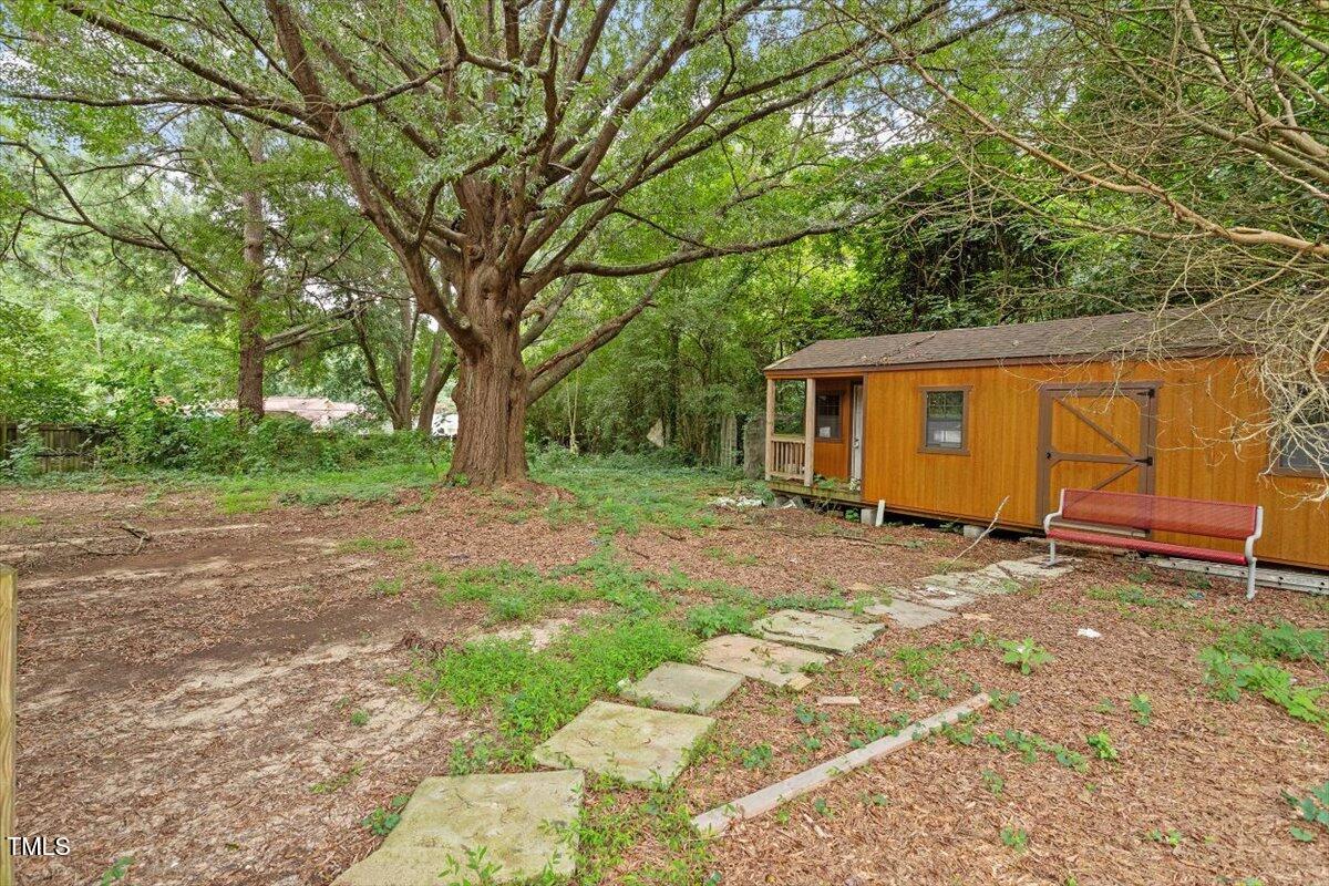 3605 Satellite Court Raleigh, NC 27604 - Photo 32 of 37 a backyard of a house with plants and large tree