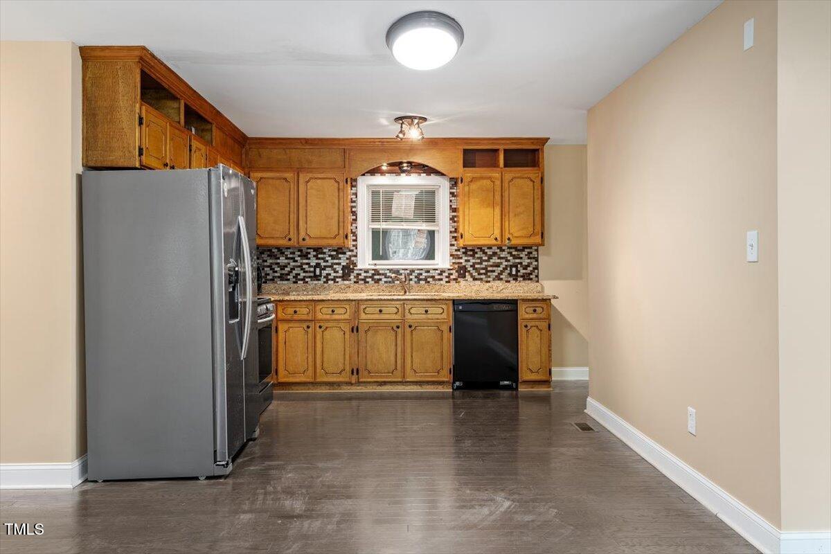 3605 Satellite Court Raleigh, NC 27604 - Photo 8 of 37 a kitchen with a refrigerator and a stove