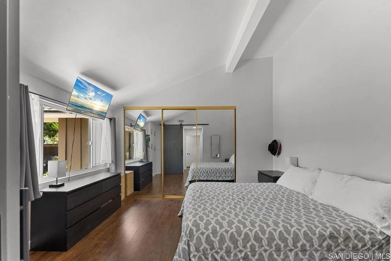 4309 Diegos Court Fallbrook, CA 92028 - Photo 14 of 33 a large bedroom with a large bed and wooden floor