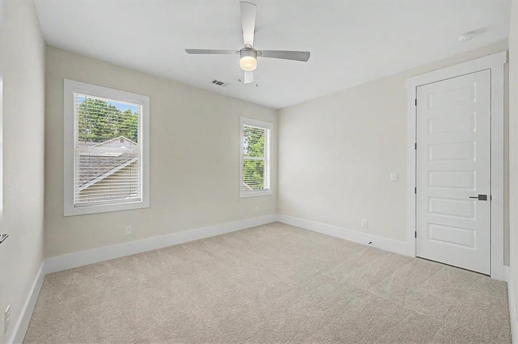 217 Laura Lake Road Marietta, GA 30066 - Photo 43 of 54 an empty room with windows and fan