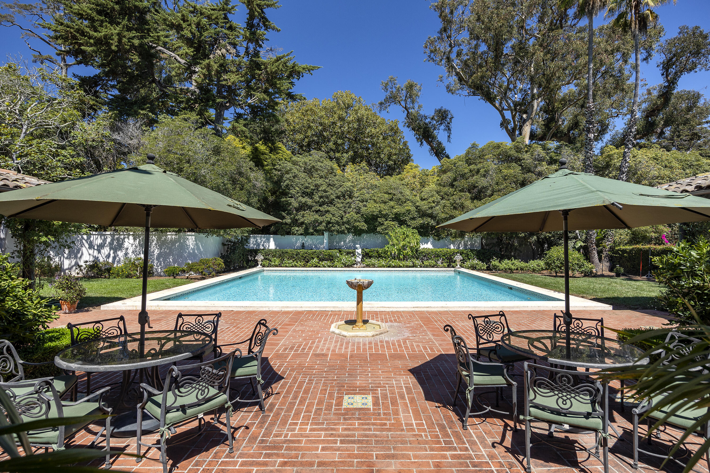 2925 Sycamore Canyon Road Montecito, CA 93108 - Photo 15 of 19 a view of pool with table and chairs under an umbrella