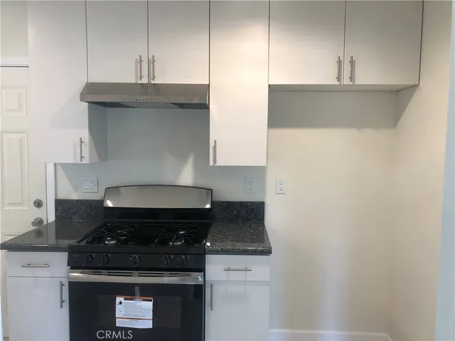 a close view of a stove a microwave and cabinets in the kitchen