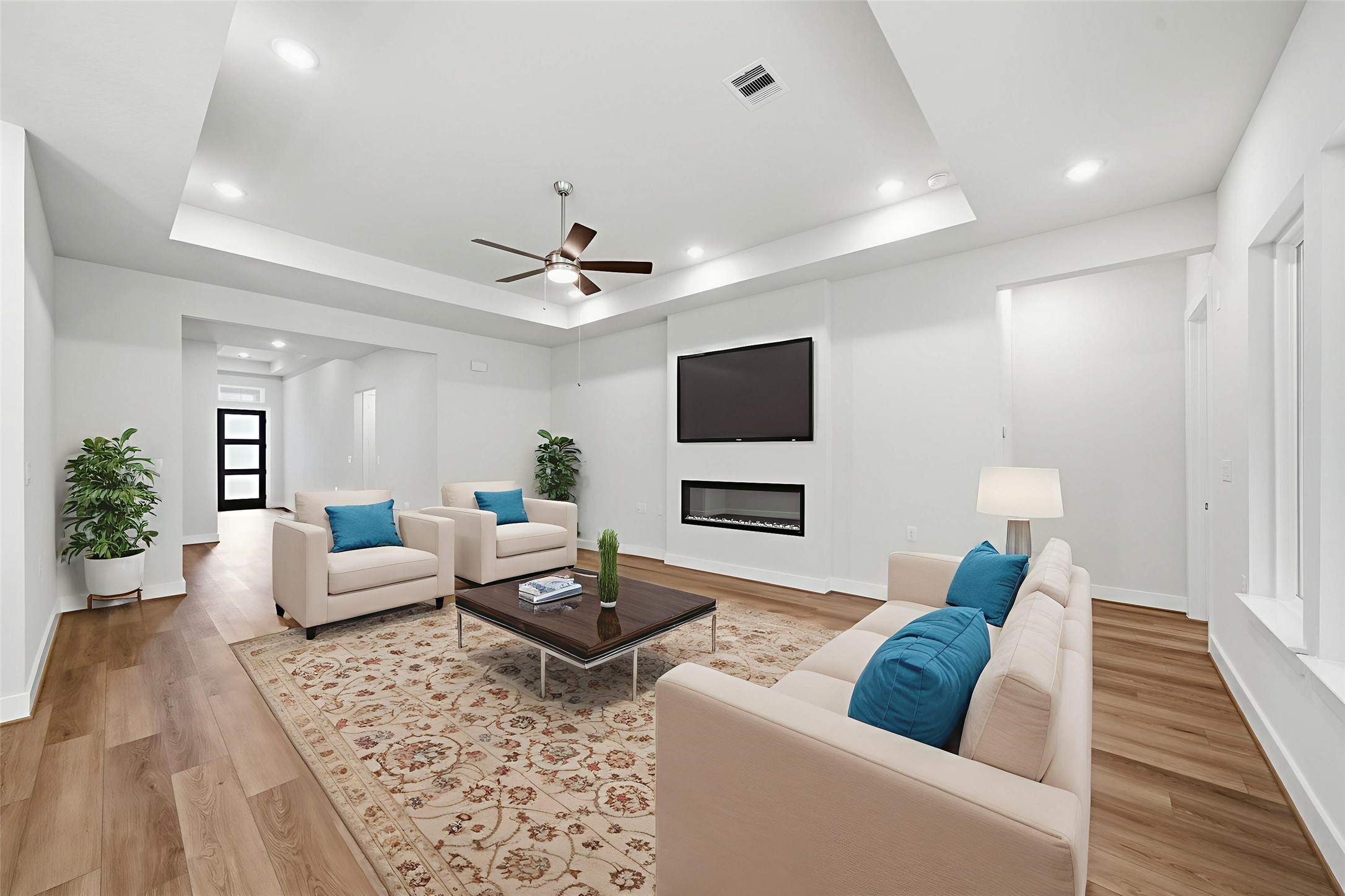 10026 Larkin Cove Willis, TX 77318 - Photo 6 of 44 The living room offers a welcoming space with an electric fireplace, ideal for cozy evenings or hosting guests in comfort and style.