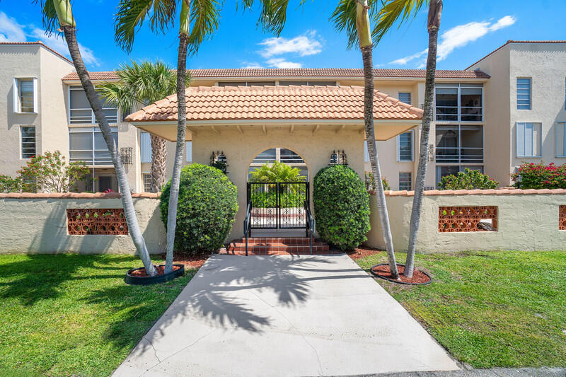 331 Southwest 8th Street, Unit 2CE Boca Raton, FL 33432 - Photo 2 of 19 a front view of a house with garden