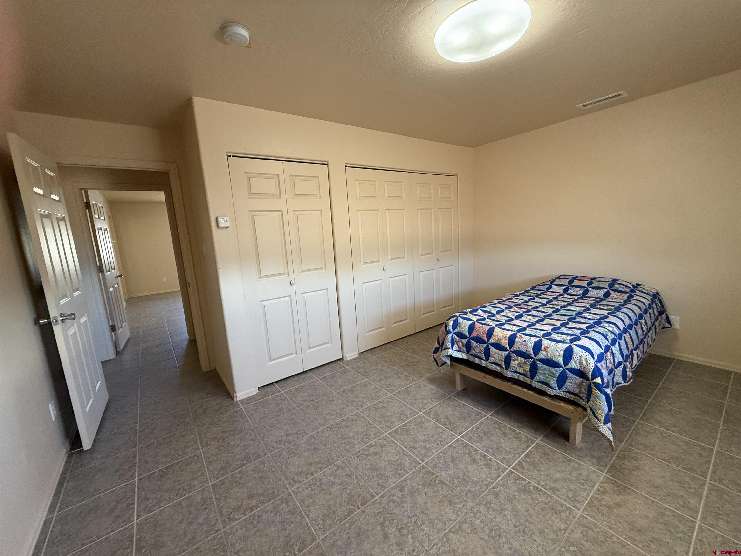 9940 2150th Road Austin, CO 81410 - Photo 11 of 44 a bedroom with a bed and a mirror