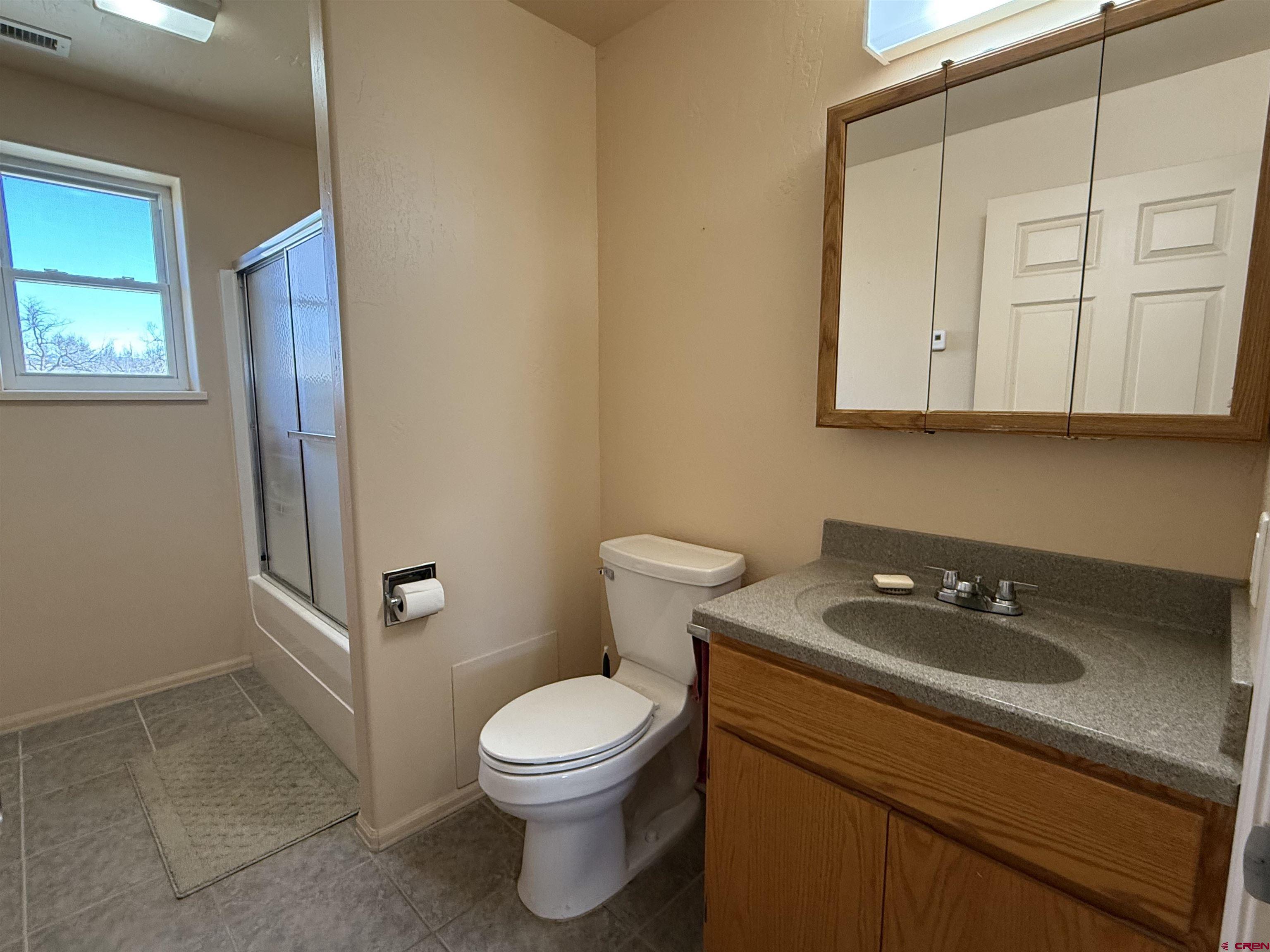 9940 2150th Road Austin, CO 81410 - Photo 12 of 44 a bathroom with a sink a toilet and vanity