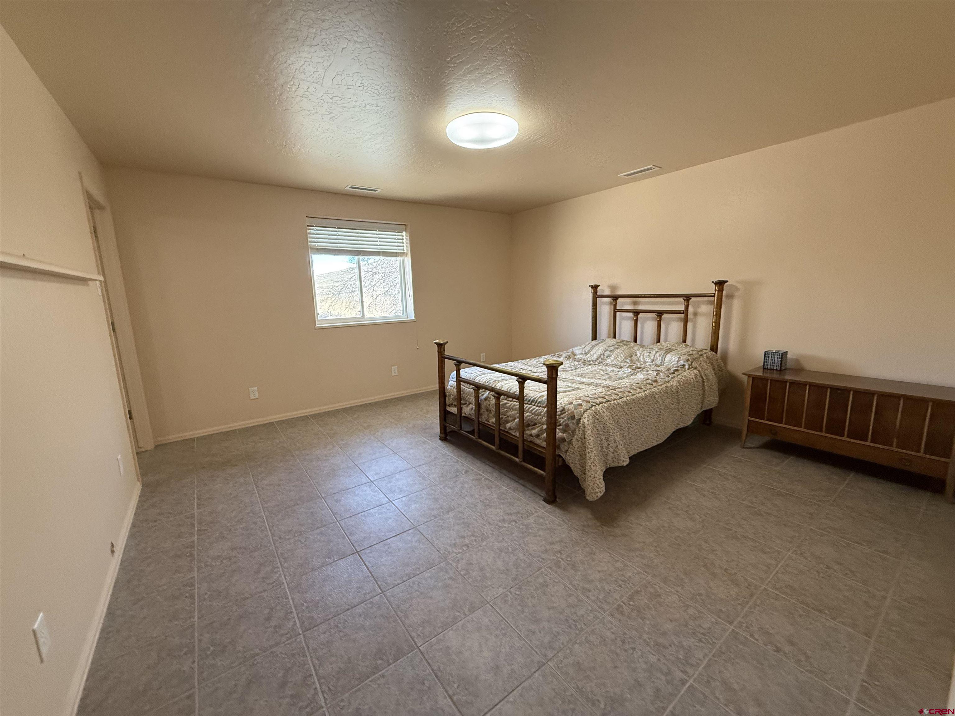 9940 2150th Road Austin, CO 81410 - Photo 14 of 44 a spacious bedroom with a bed and a window