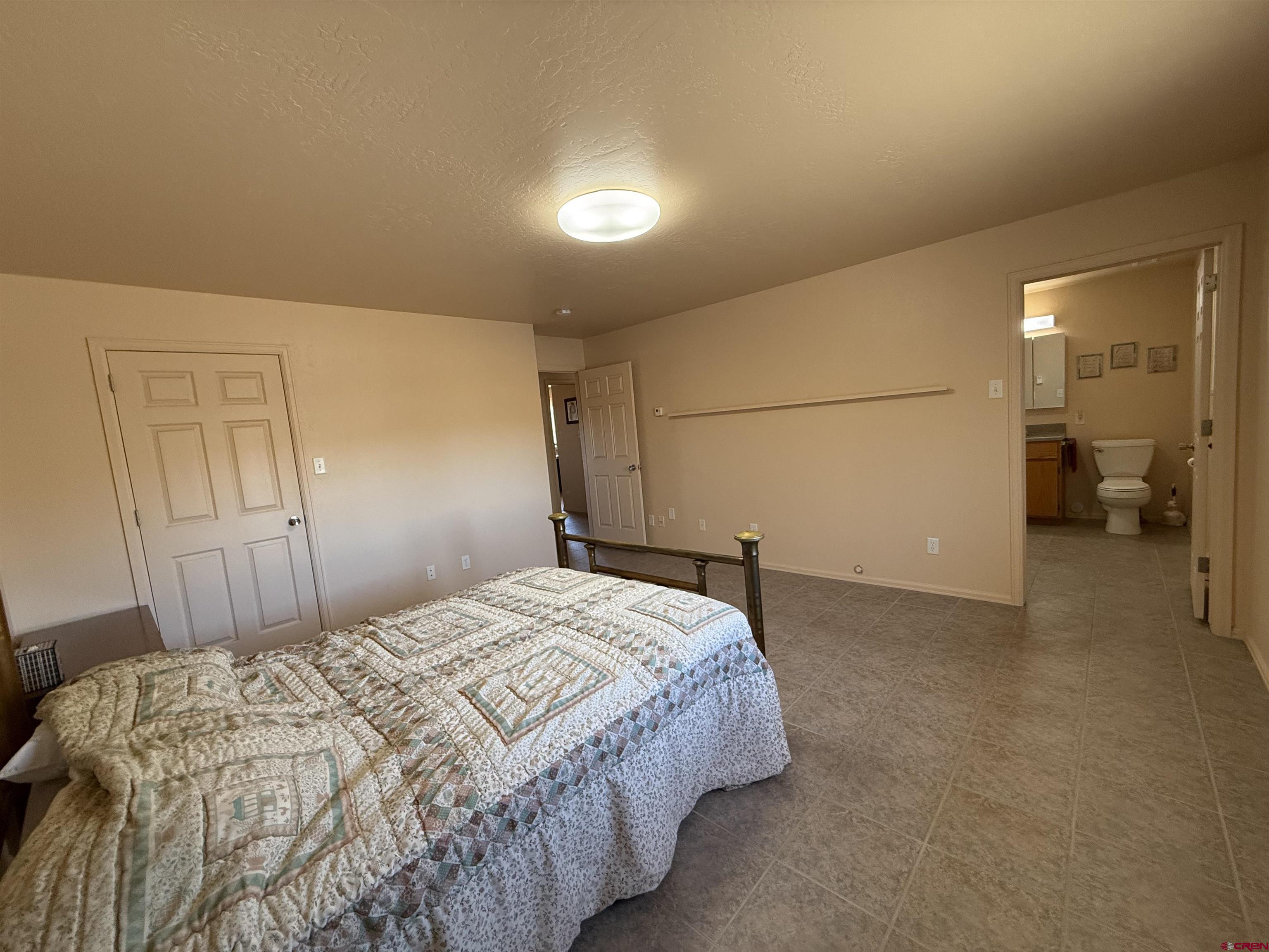 9940 2150th Road Austin, CO 81410 - Photo 15 of 44 a bedroom with a bed and a view of bathroom