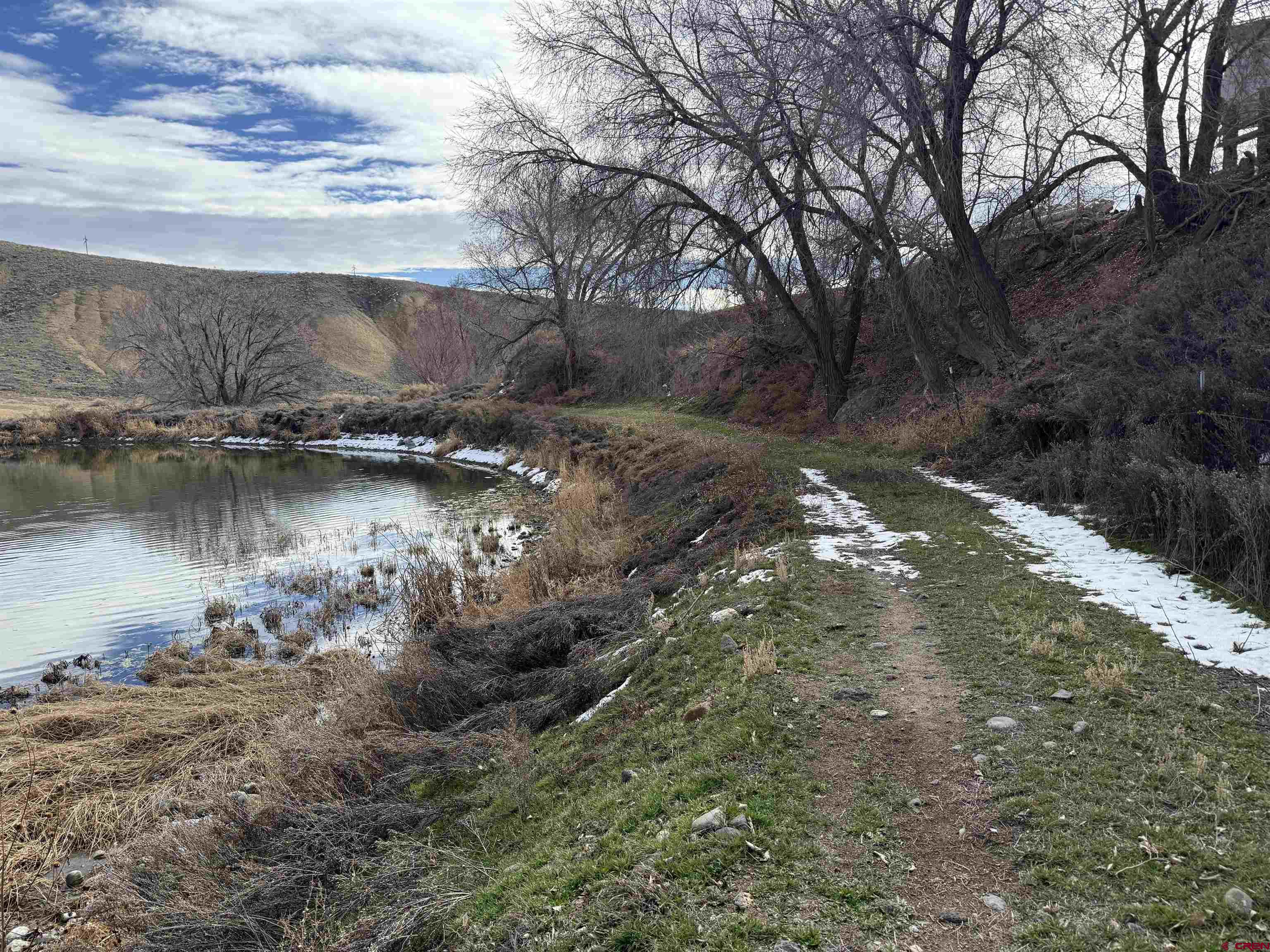 9940 2150th Road Austin, CO 81410 - Photo 32 of 44 a view of a lake in between two of trees