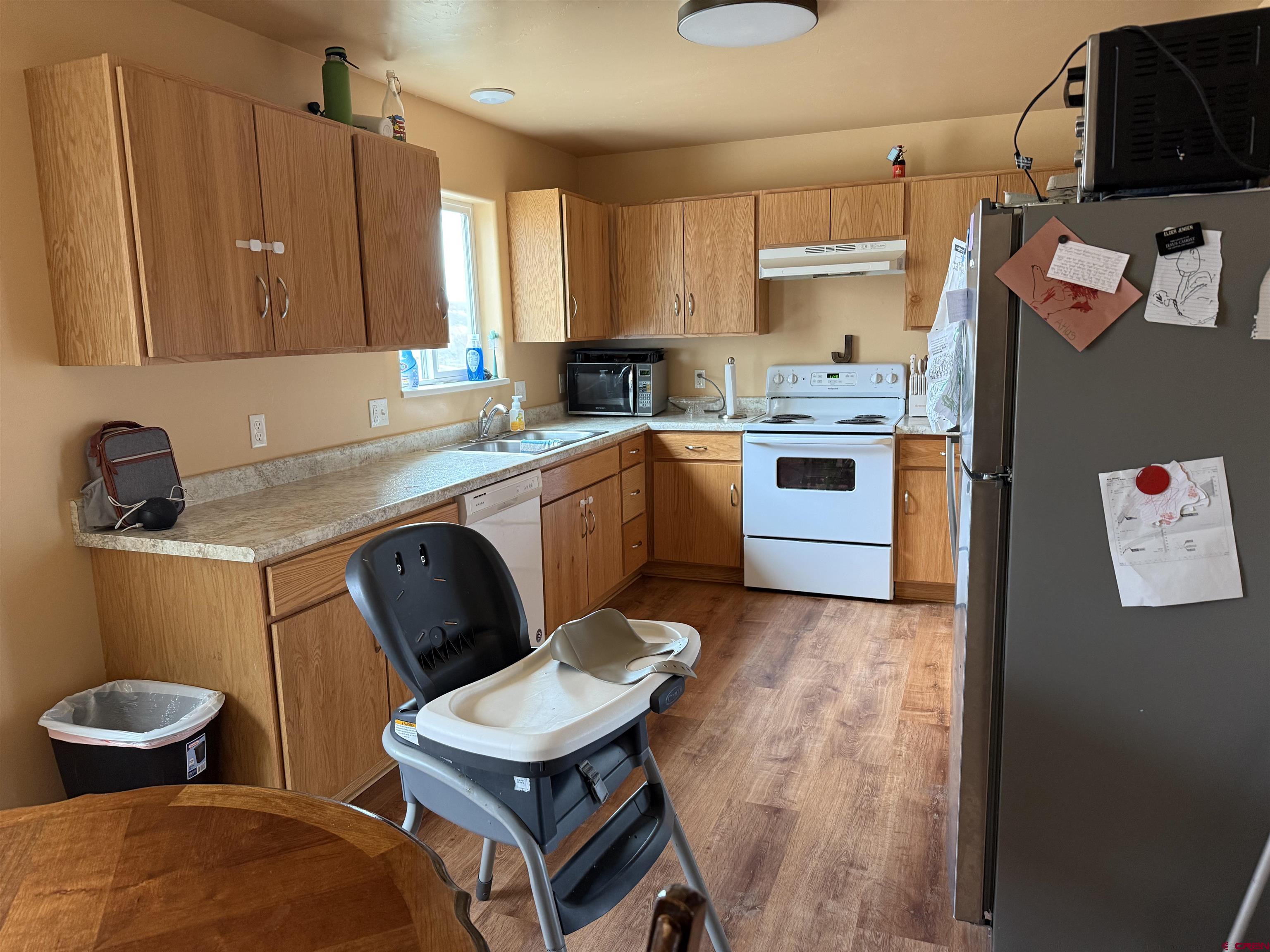 9940 2150th Road Austin, CO 81410 - Photo 38 of 44 a kitchen with stainless steel appliances a stove a sink dishwasher and cabinets