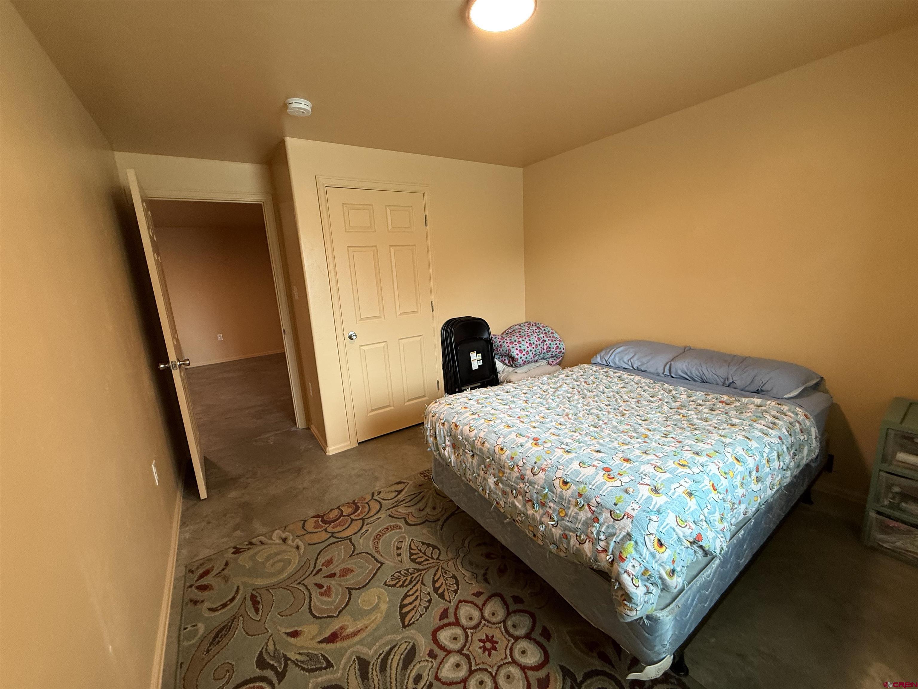 9940 2150th Road Austin, CO 81410 - Photo 42 of 44 a bedroom with a bed and a mirror
